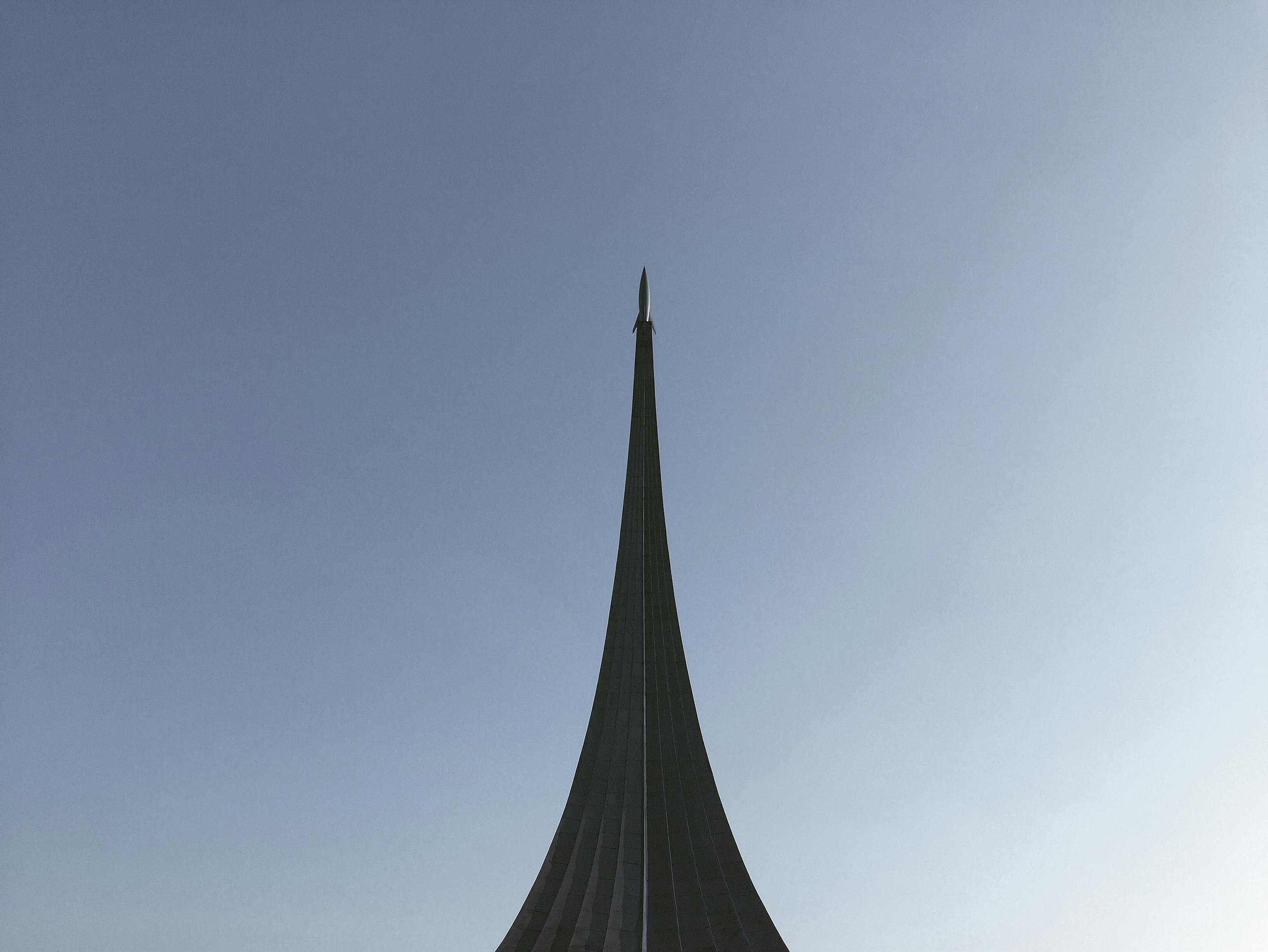 The Space Conquerors Monument under a clear blue sky in Moscow, Russia.